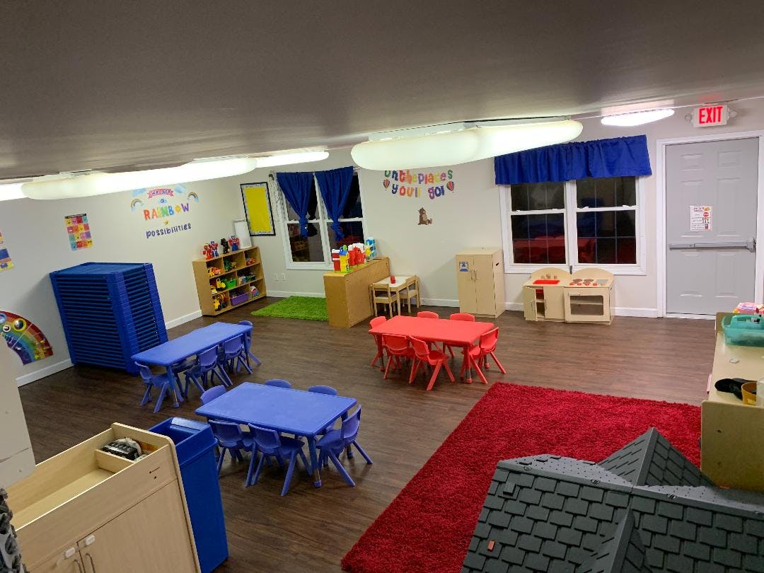 Classroom with small blue and red tables and chairs