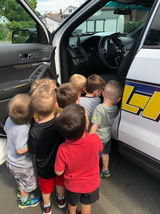 Group of children looking into an open car door