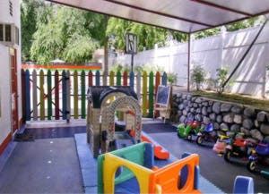 Outdoor play area with colorful play structures and toys