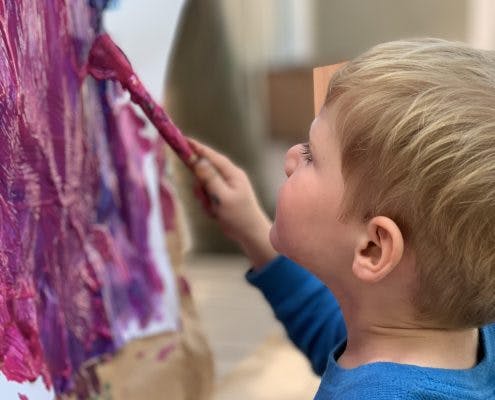 Child painting with a brush
