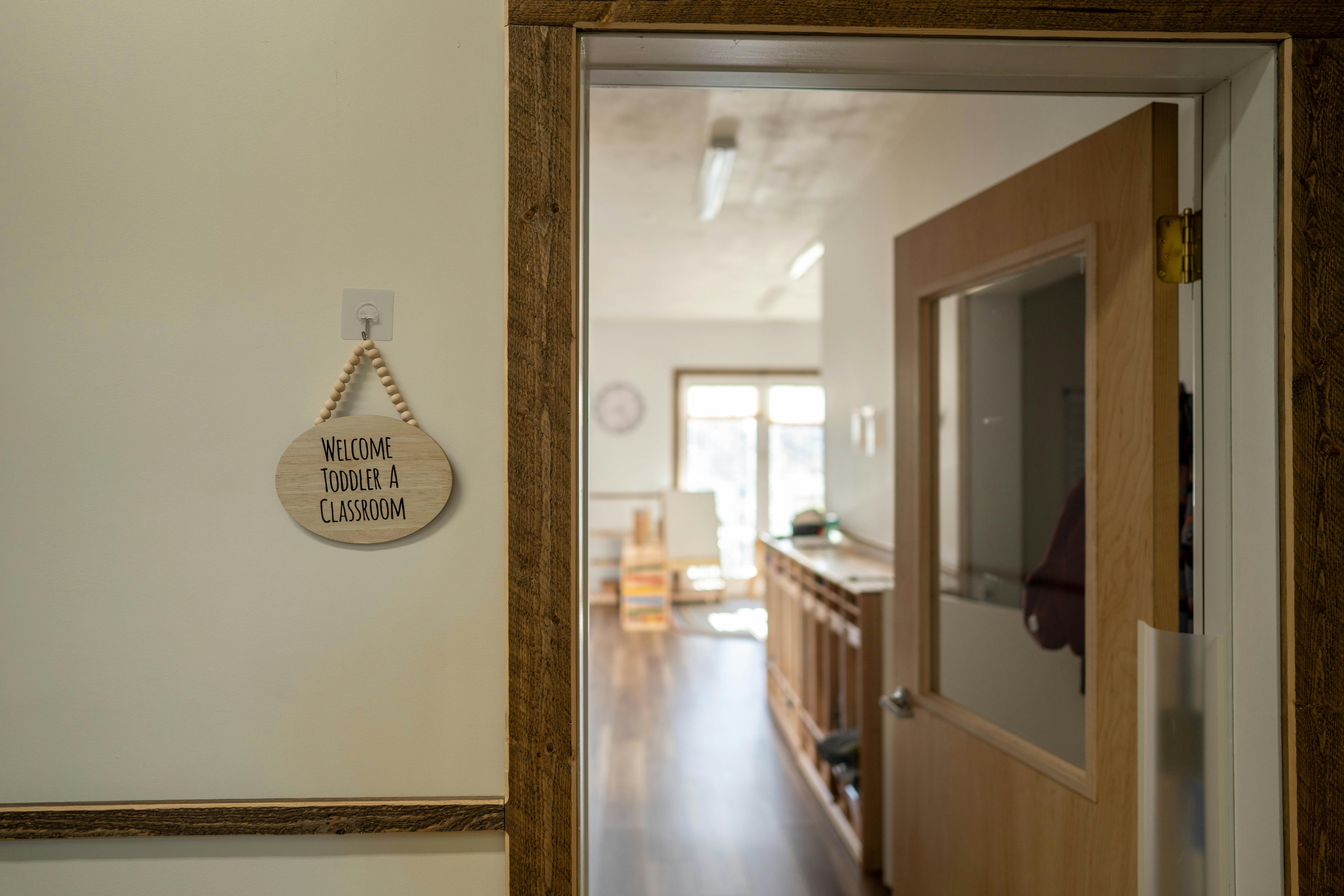 Wooden sign on wall with text "Welcome to our classroom"