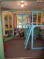Child's room with a loft bed and a bookshelf