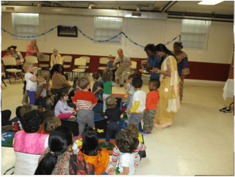Adults and children gathered in a room
