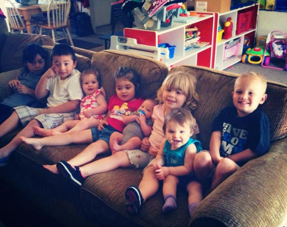 Group of children and babies sitting on a couch