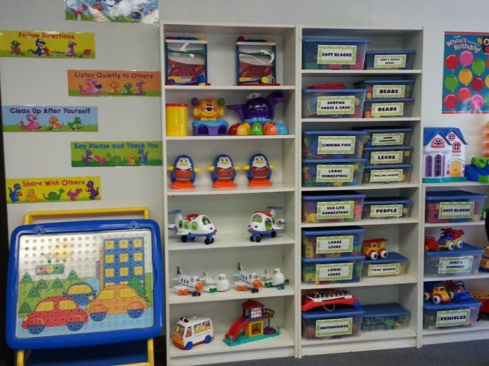 Shelves filled with toys and storage bins in a classroom