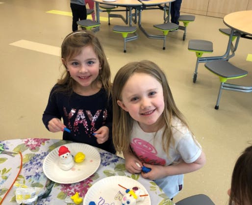 Two children at a table with crafts