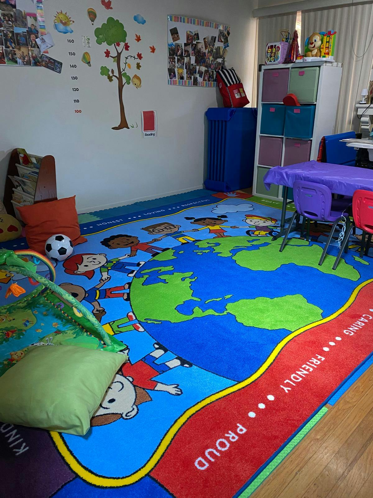 Classroom with a large rug depicting a world map and diverse children