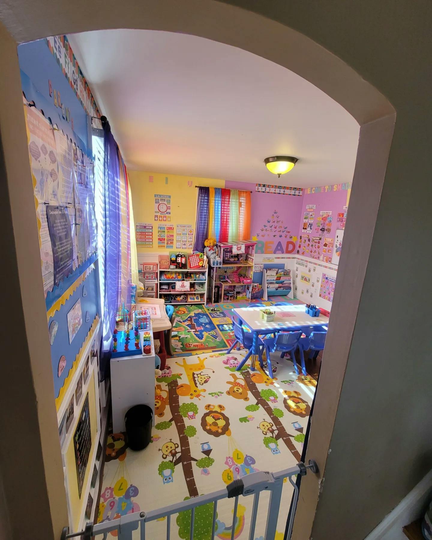 A colorful classroom with tables, chairs, and educational decorations