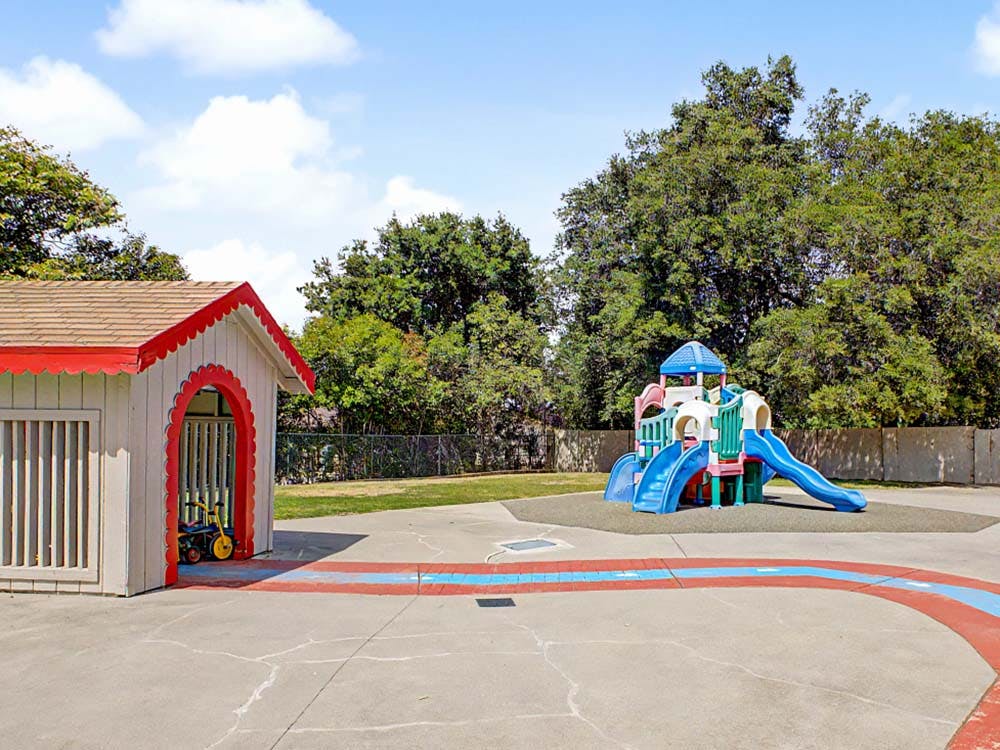 Playground with a playhouse and colorful slide structure