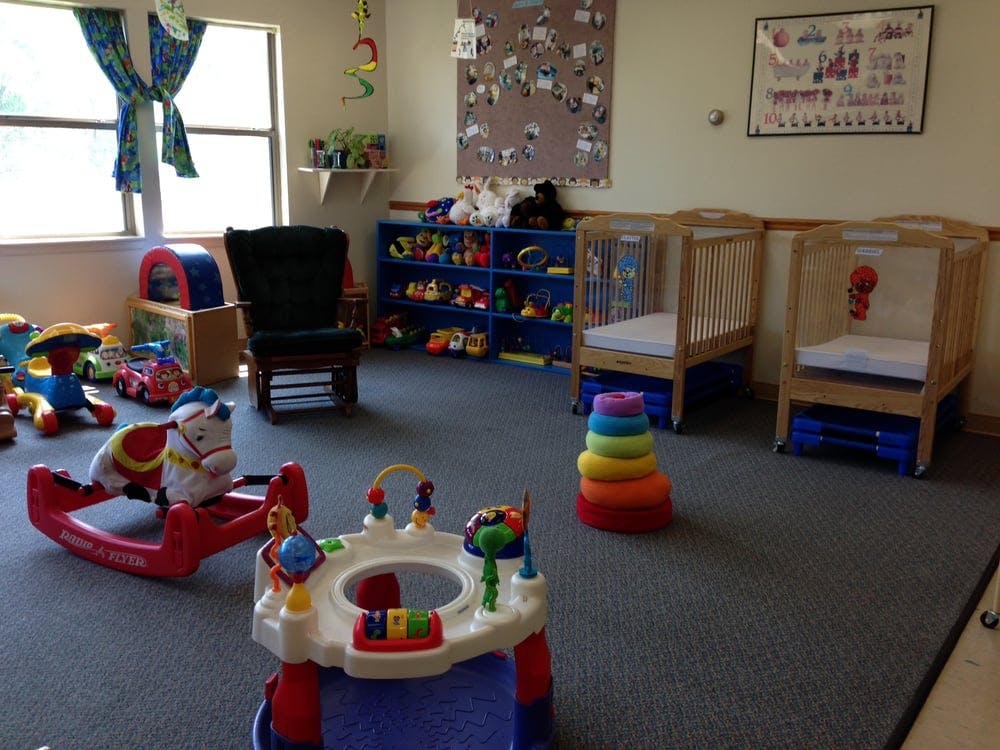 Playroom with cribs, rocking horse, and various toys