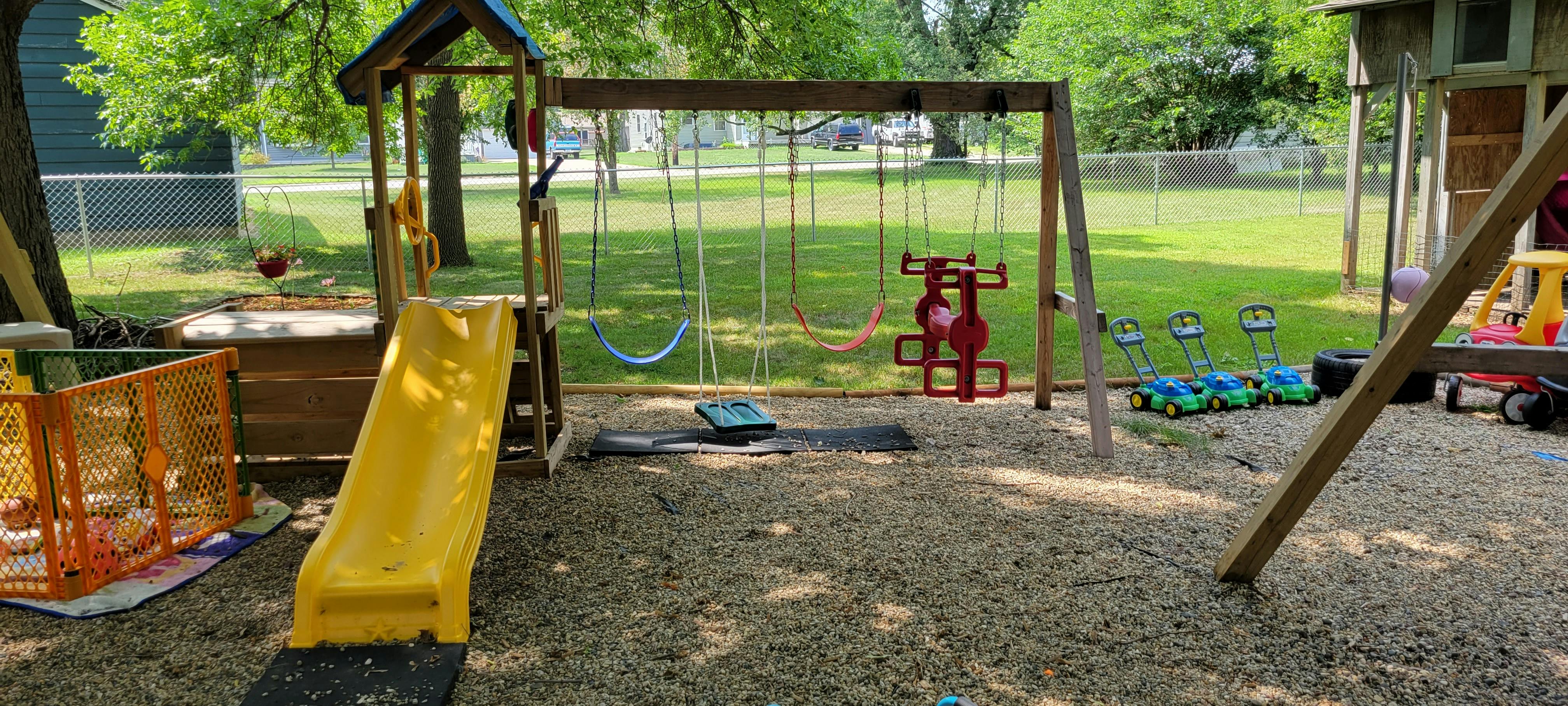 Playground with a yellow slide and swings