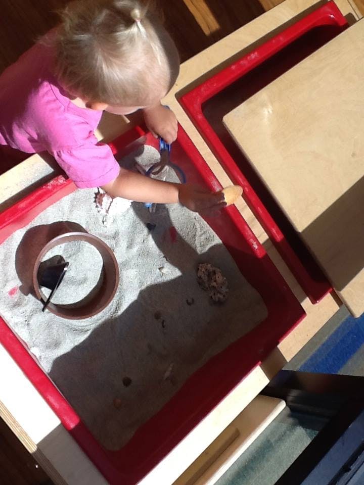 Child playing in a sand table