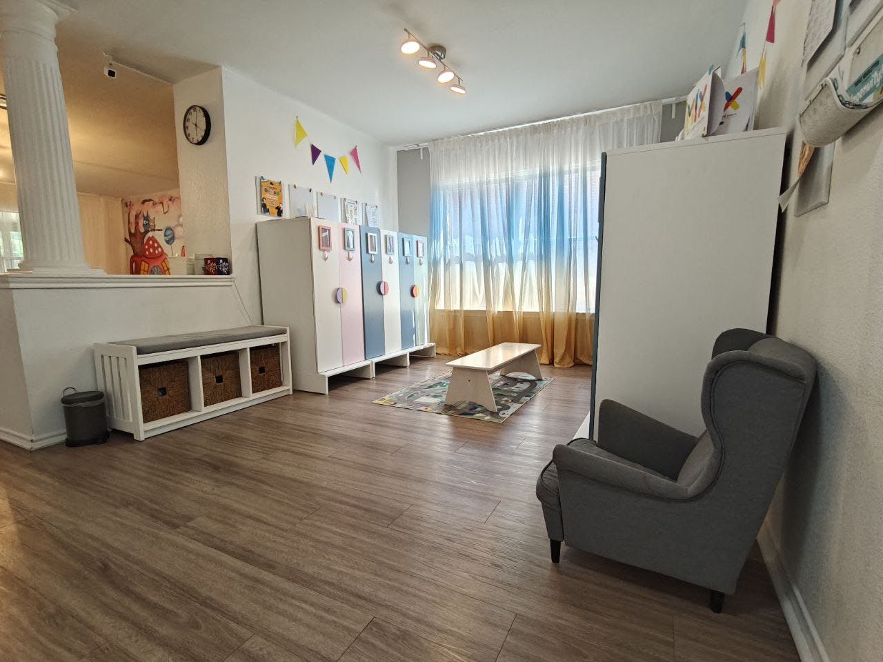 Room with lockers, a bench, and an armchair