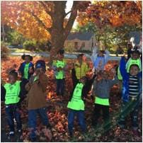 Children playing in autumn leaves