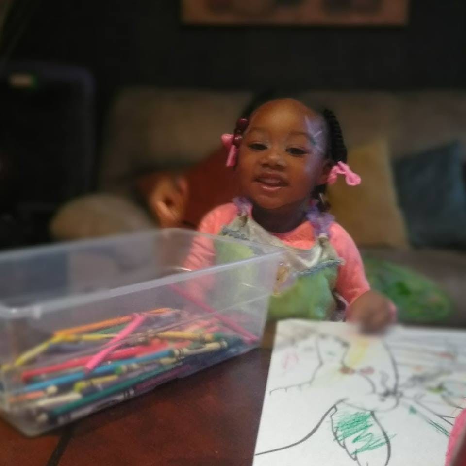 Child coloring a picture with crayons