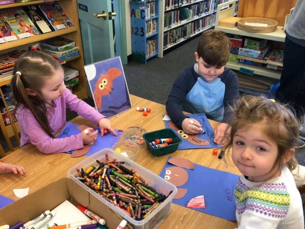 Three children doing crafts at a table