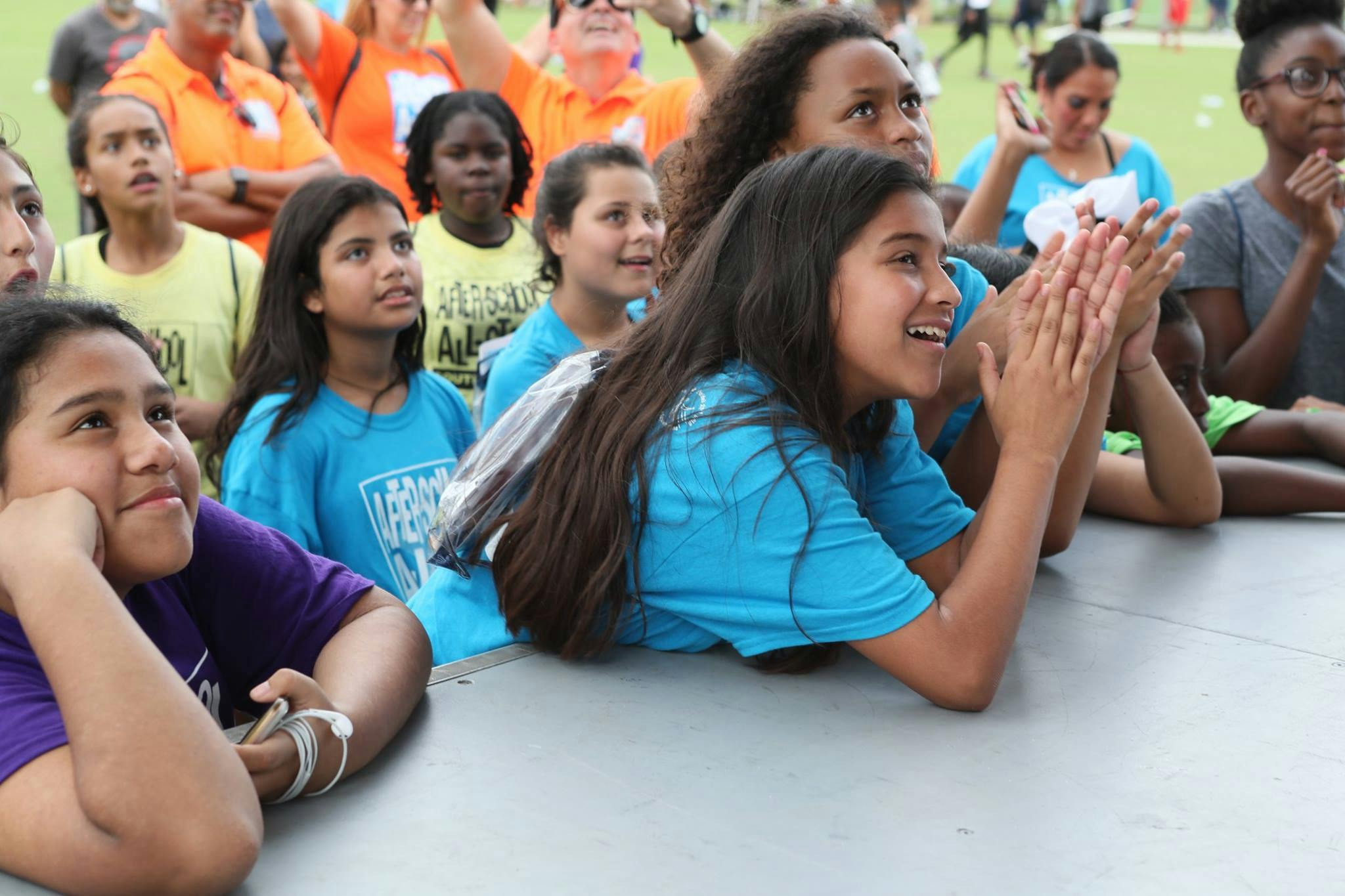 Group of children and teens watching an event