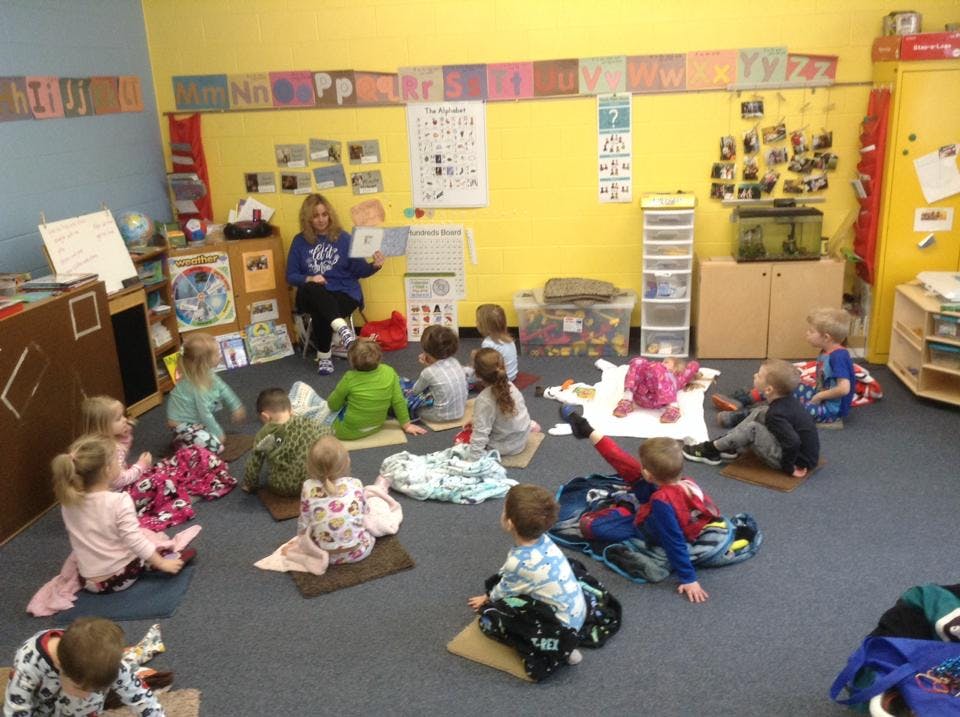 Person reading to children in a classroom