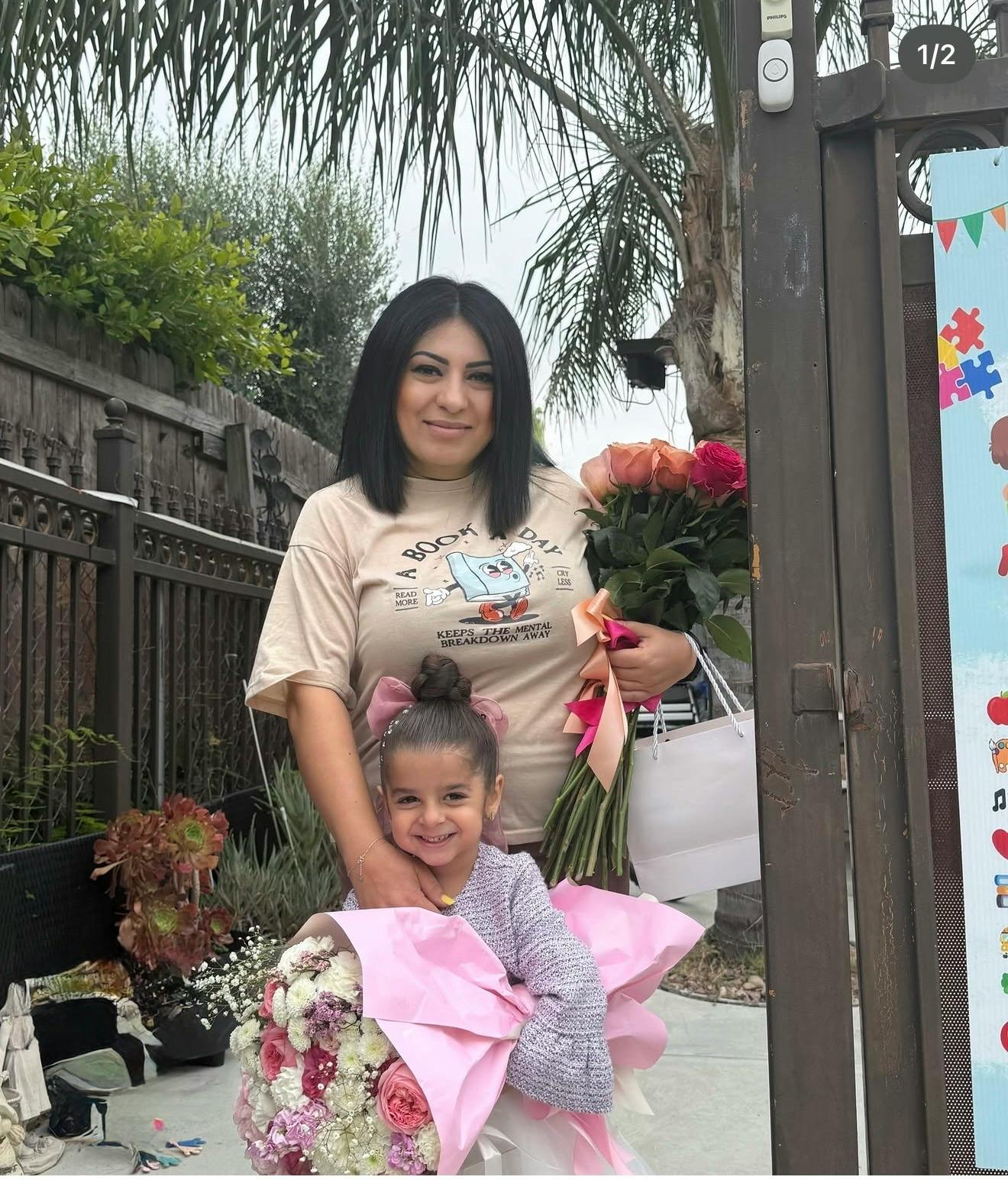 A person and a child holding large flower bouquets outdoors