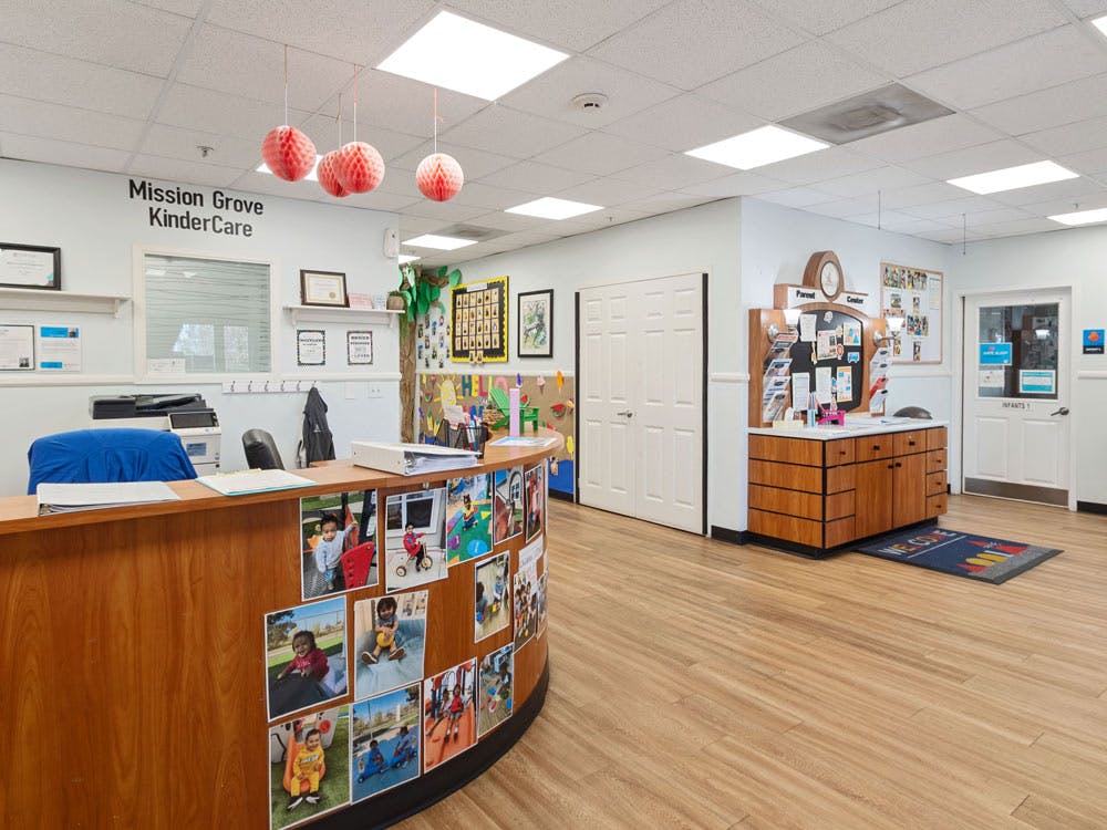 Reception area of a KinderCare facility, with a desk and bulletin boards