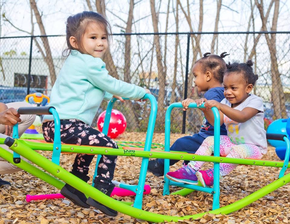 Three children on a seesaw