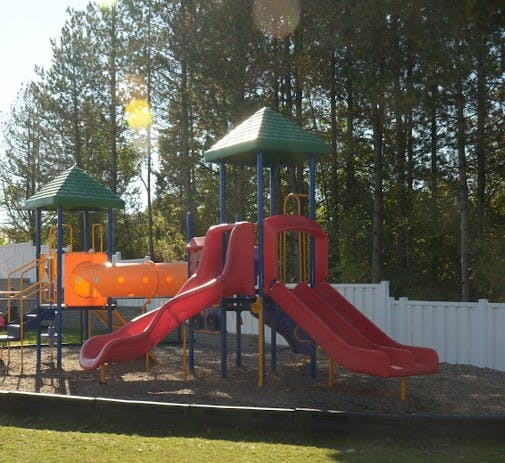 Colorful playground with multiple slides and a tunnel