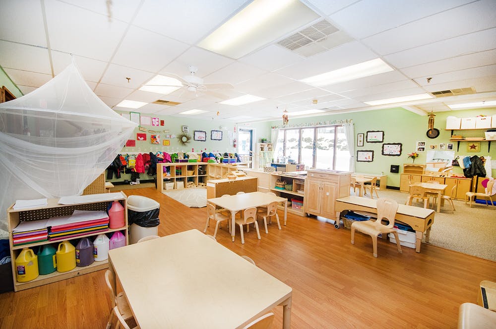 Empty classroom with small tables and chairs