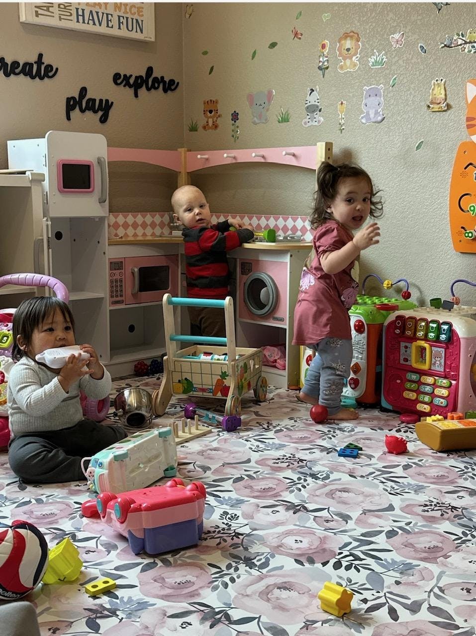 Three children playing with toys in a room