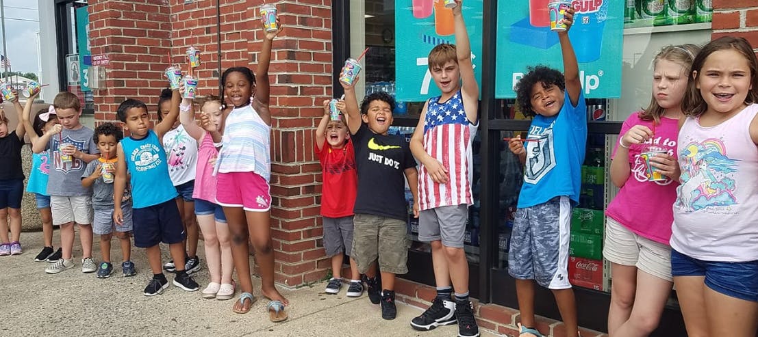 Group of children holding up cups
