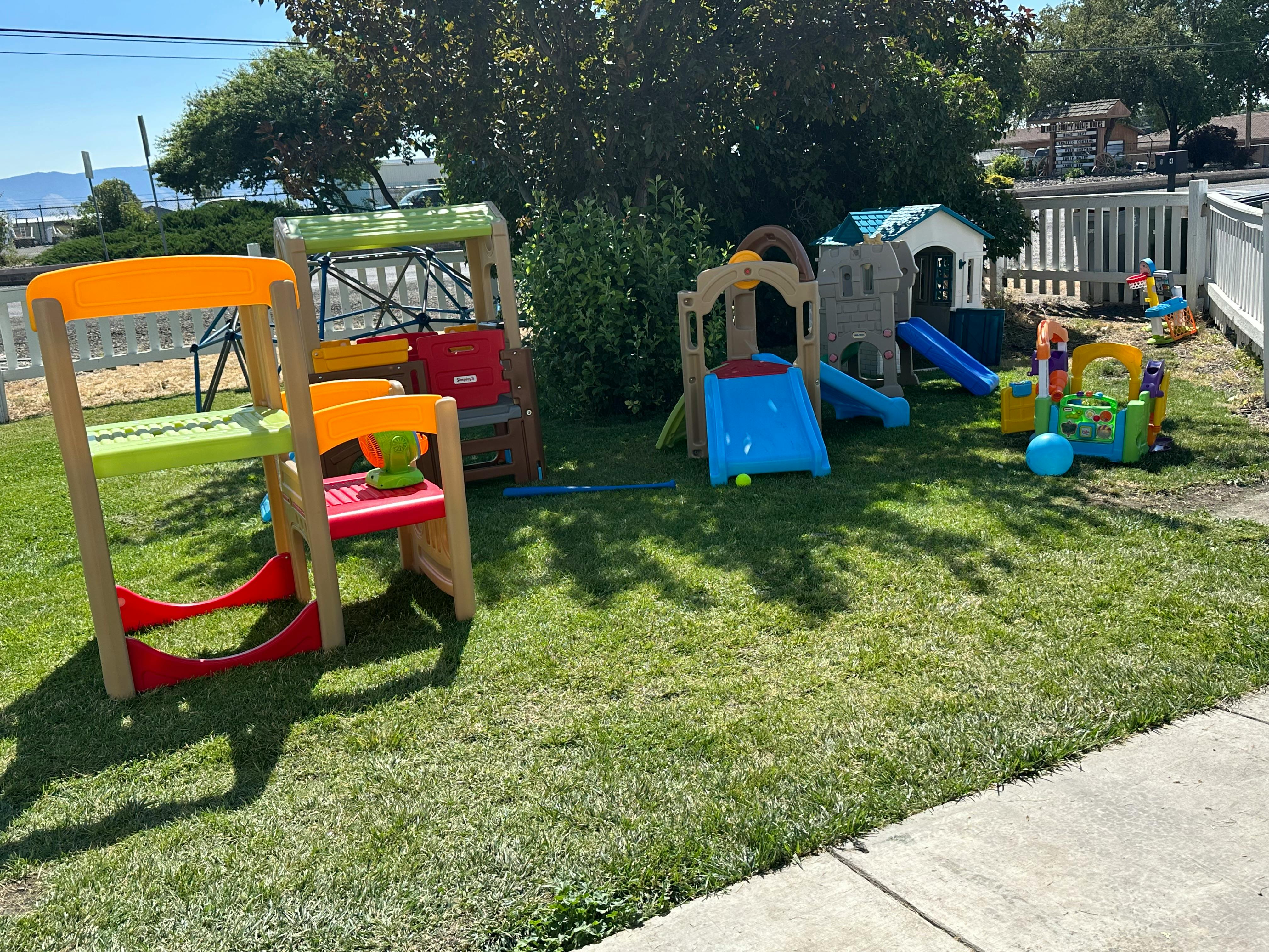 Outdoor playground with slides and play structures on grass