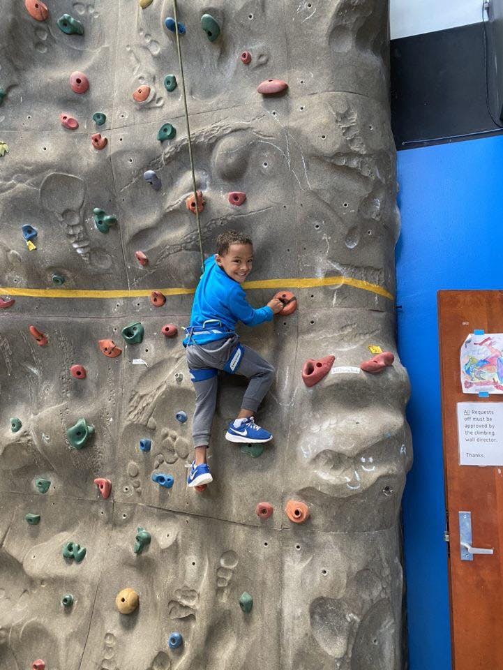 Child climbing a rock wall