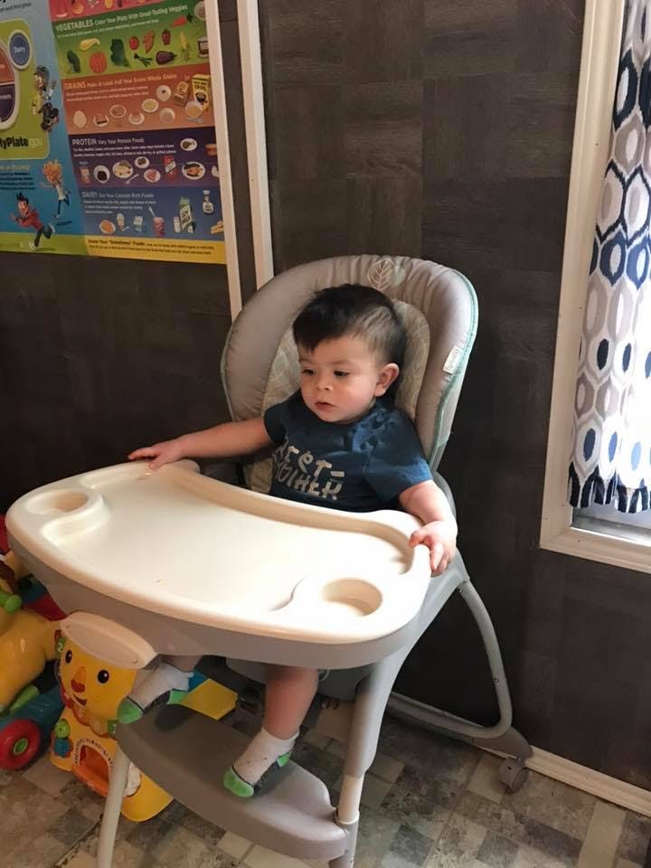 Child sitting in a high chair