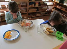 Two children at a table with plates of food