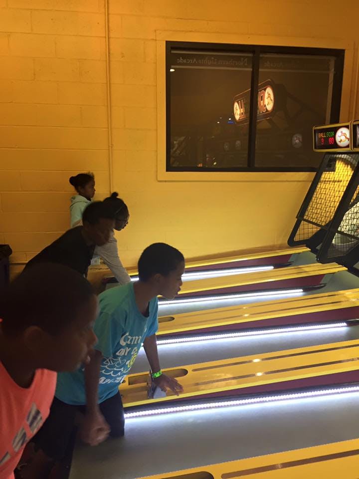 Children playing a skee-ball game