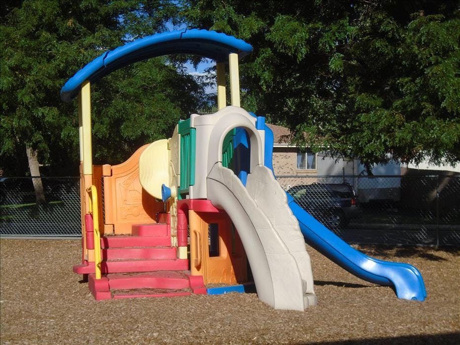 Colorful playground structure with red steps and two slides