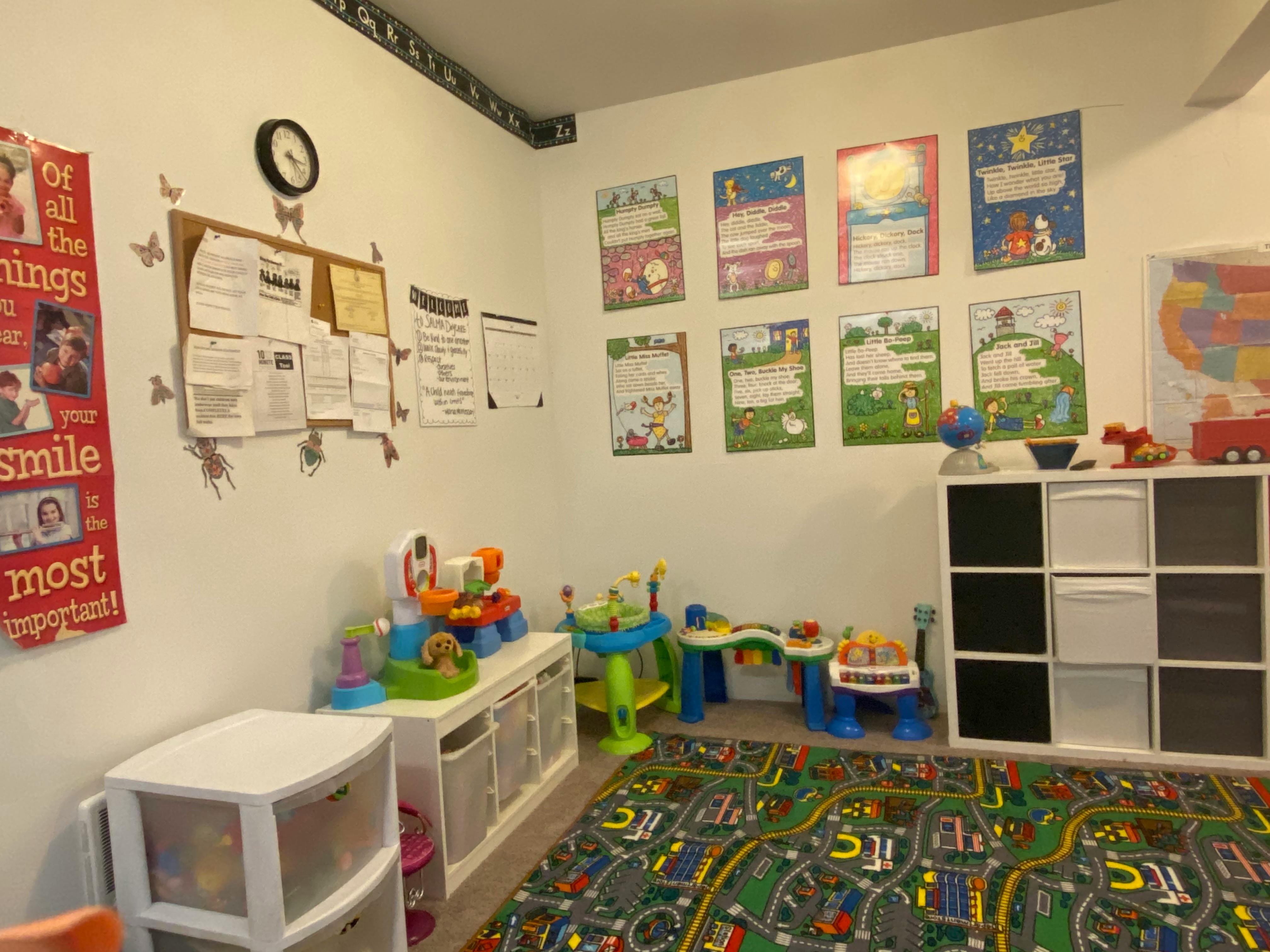 Playroom with toys, storage, and educational posters on the walls