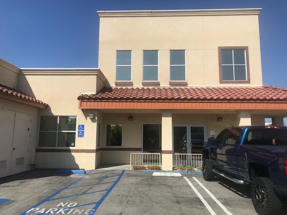 Building exterior with a blue truck parked in front