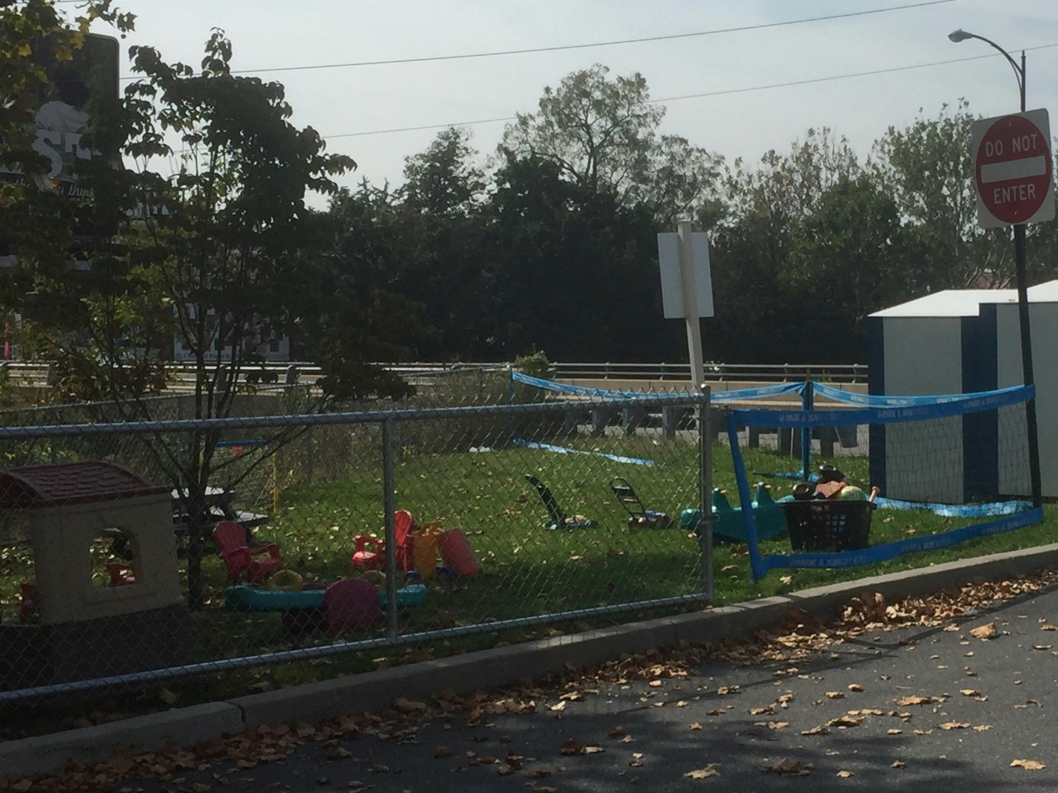 Playground with a chain link fence and blue tarp