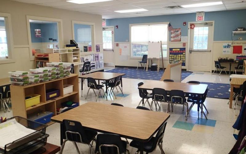 Empty classroom with small tables and chairs