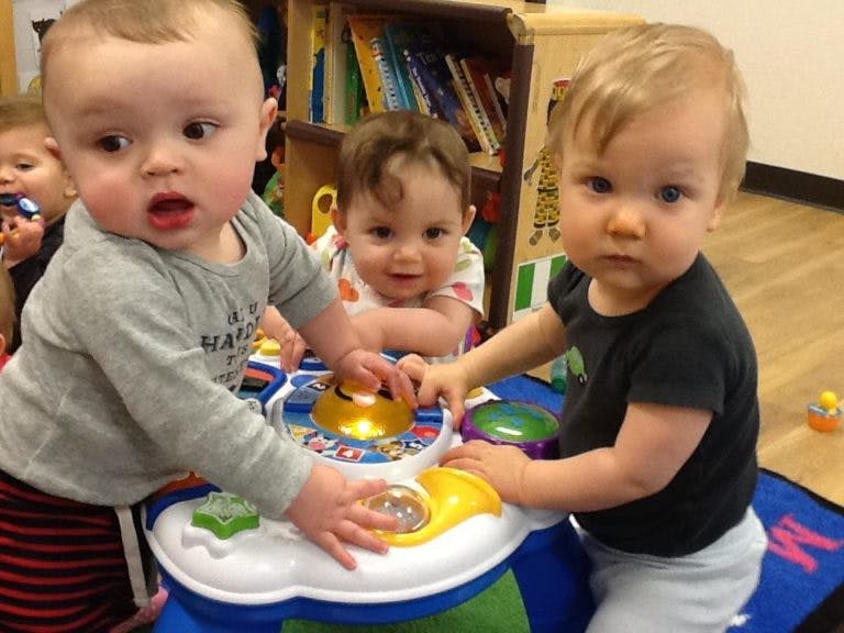 Three children playing with a toy
