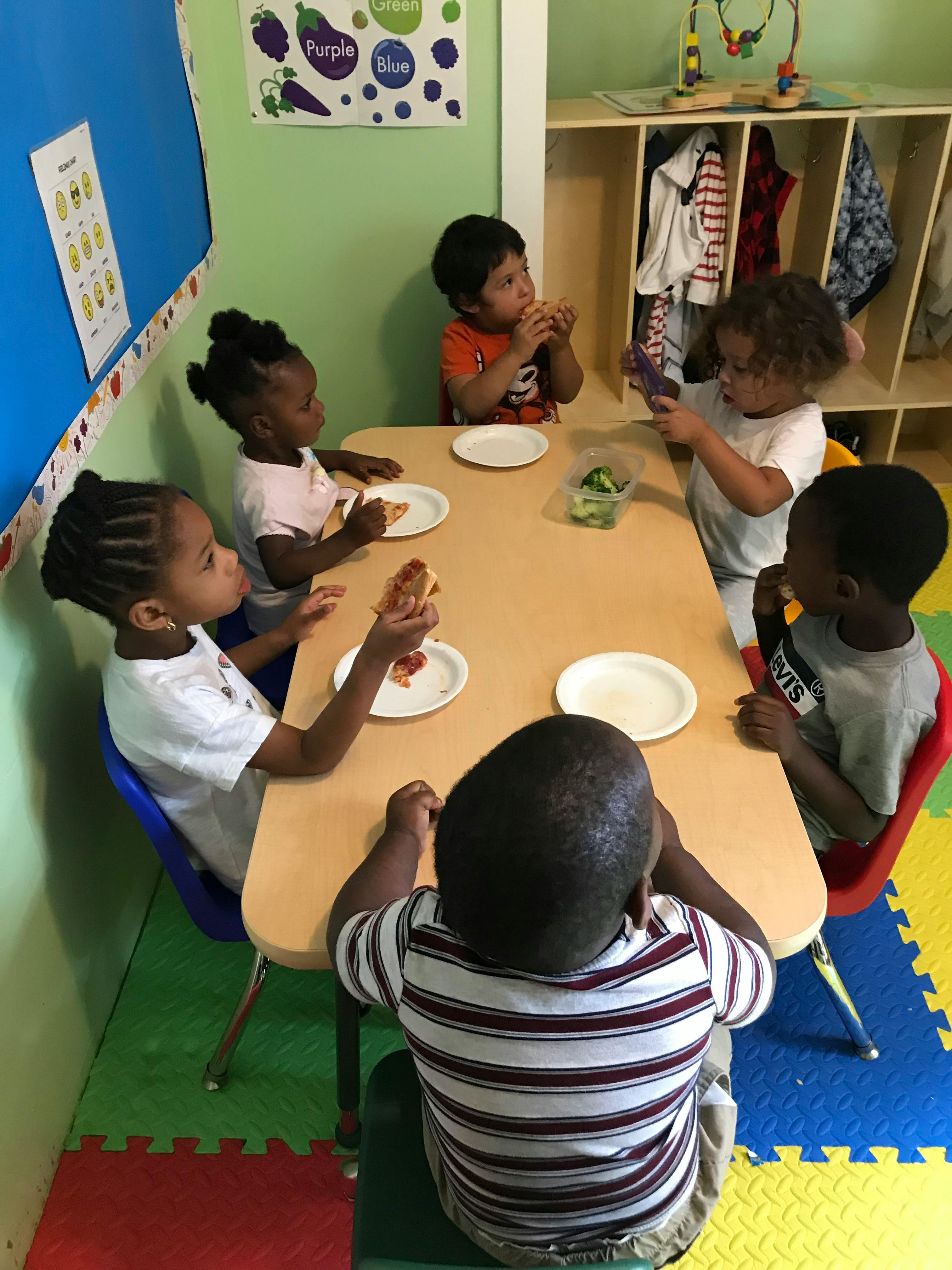 Children sitting at a table eating
