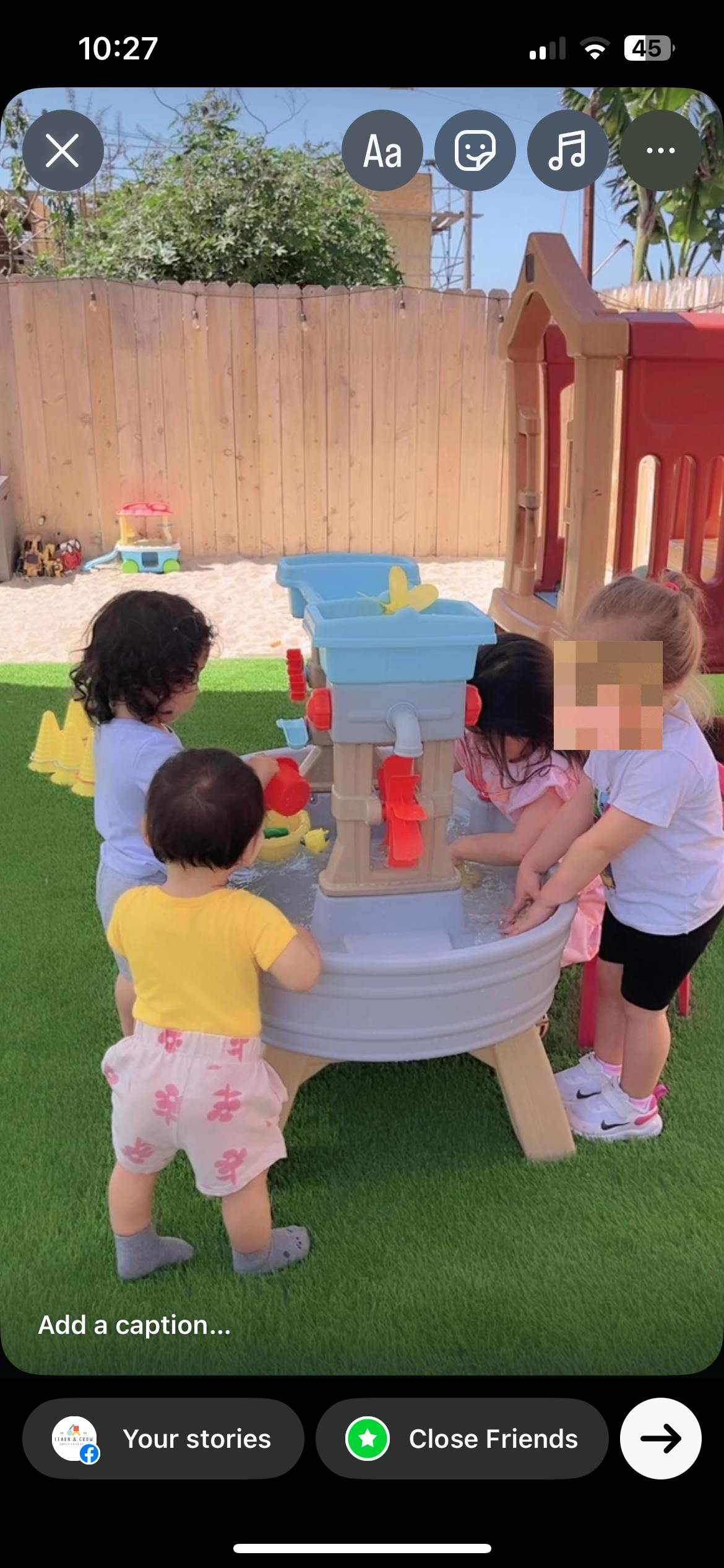 Children playing at a water table outdoors