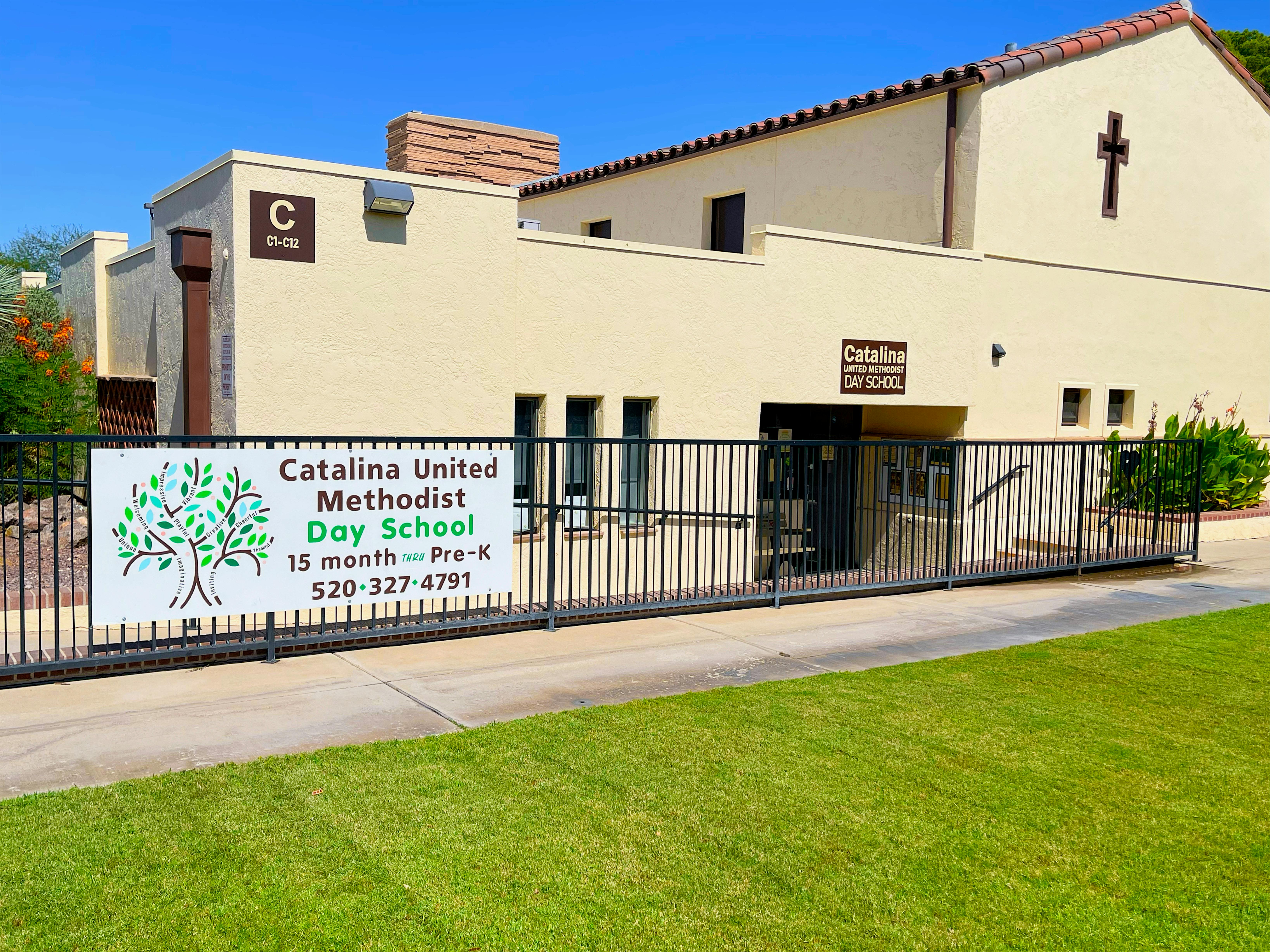 Catalina United Methodist Day School sign on a fence in front of a building