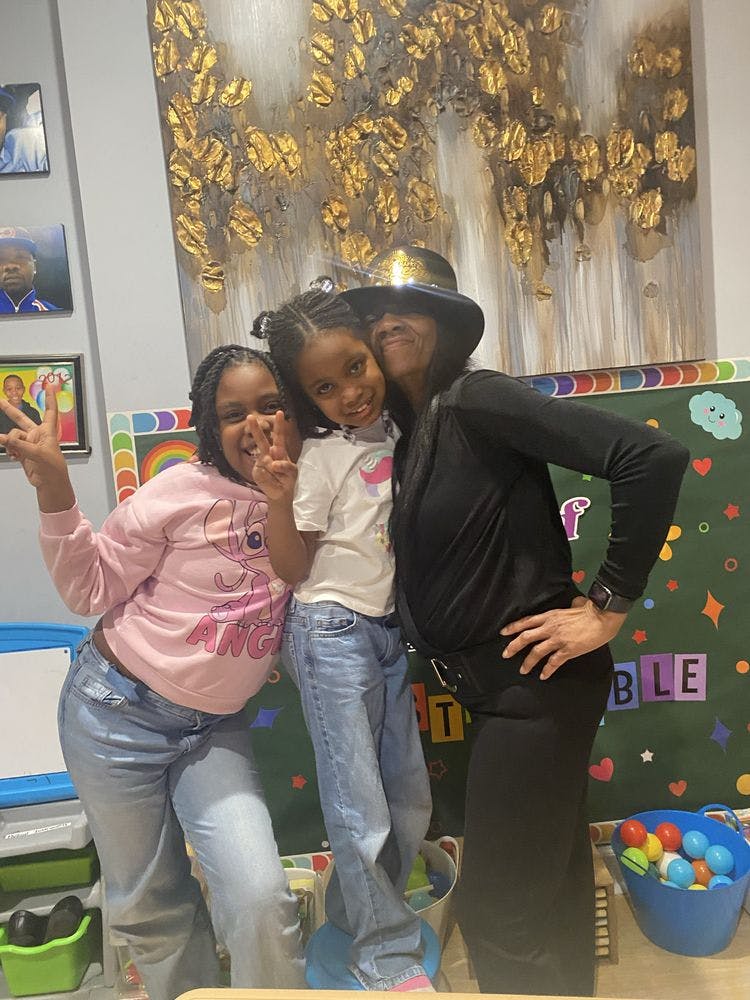 Two children and one adult posing for a photo