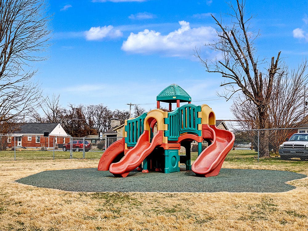 Playground equipment with two slides on a rubber mat