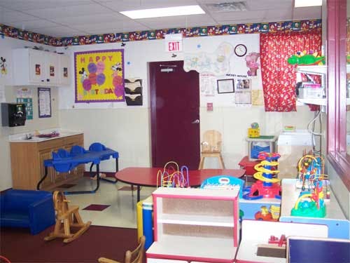 Playroom with toys, small tables, and chairs