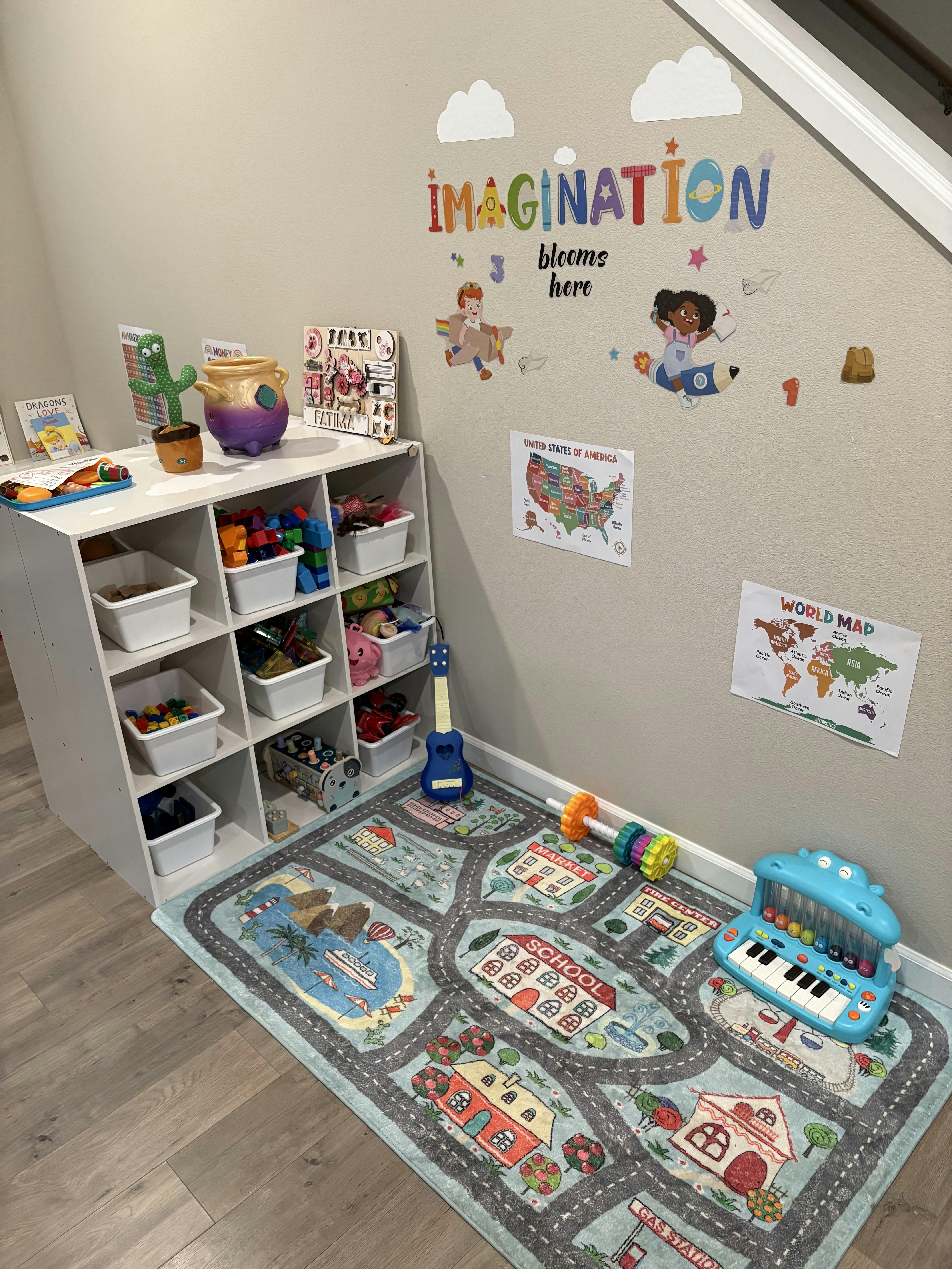 Children's play area with toy storage, road map rug, and wall decals