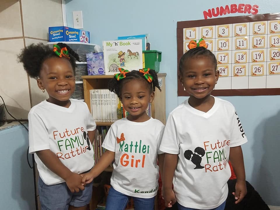 Three children in white t-shirts standing together