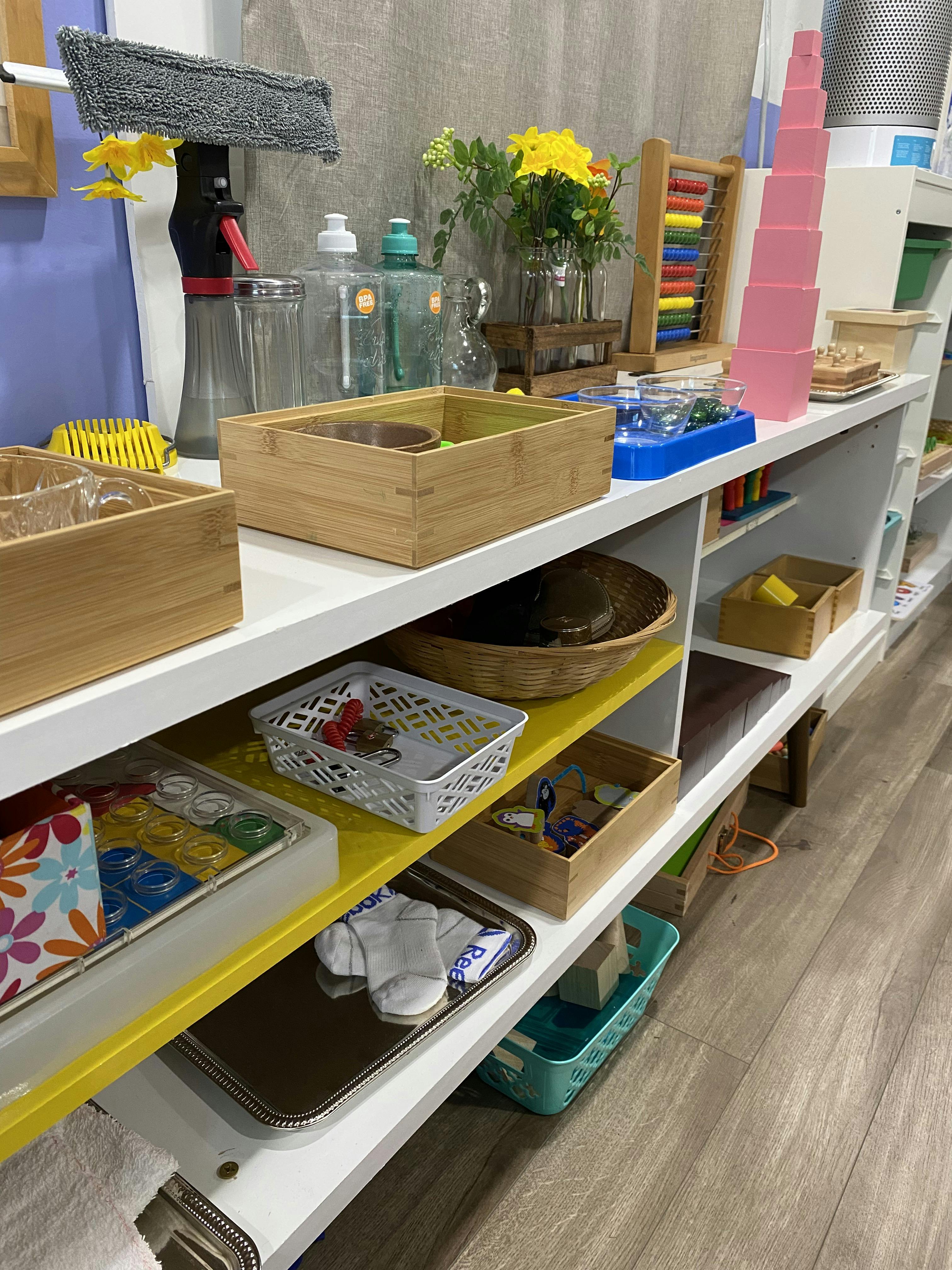 Shelves with various items including wooden boxes, baskets, and an abacus