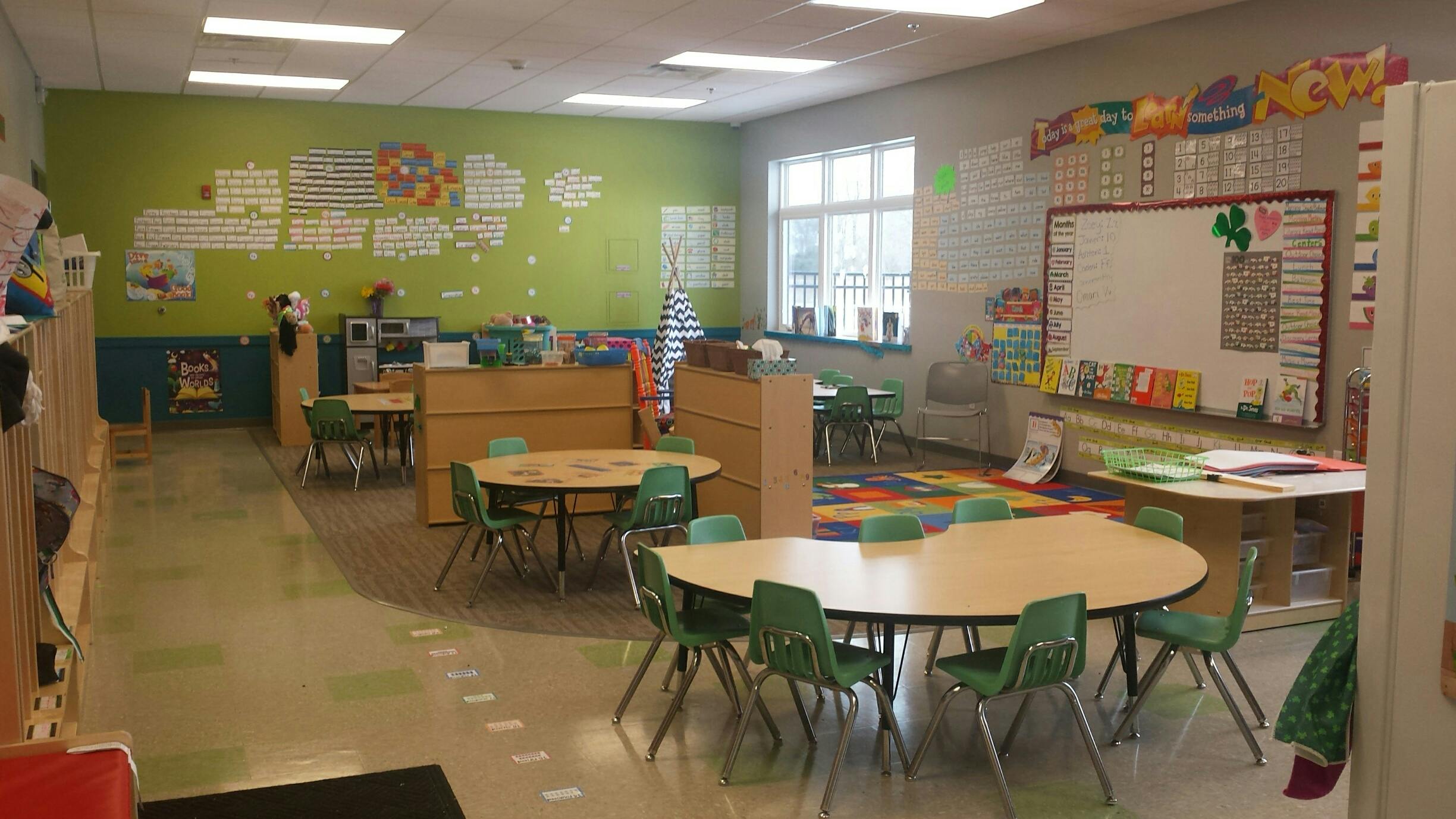 Empty classroom with small tables and chairs